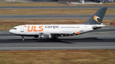 A midsize plane with ULS Cargo lettering in orange rolls own the runway