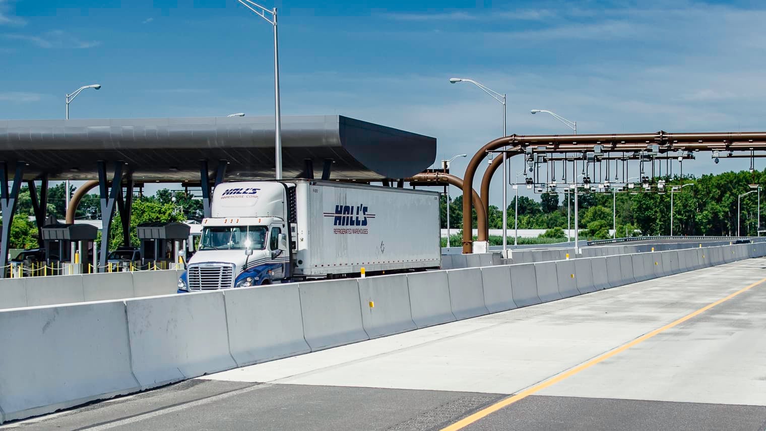 Trucks on highway passing through toll