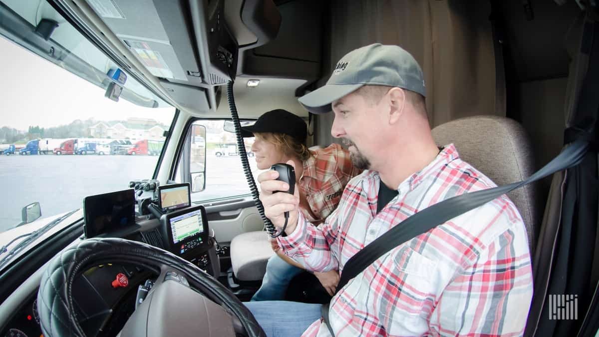 Male/Female driver team in truck cab.