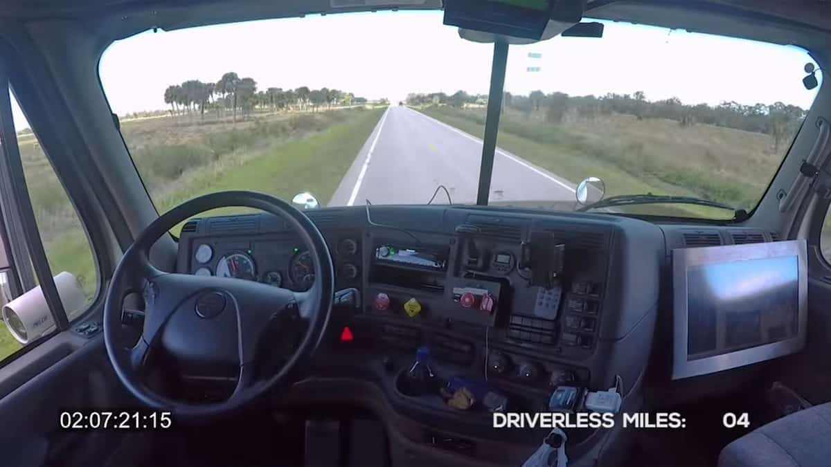 A truck without a driver moves down the road.