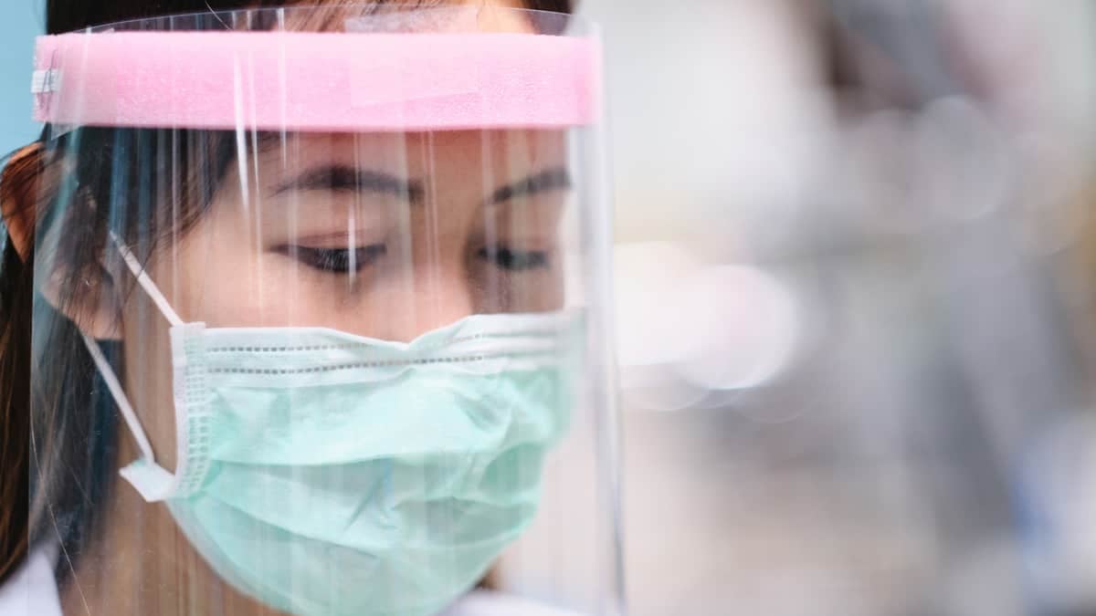 Healthcare worker wearing protective mask and face shield.