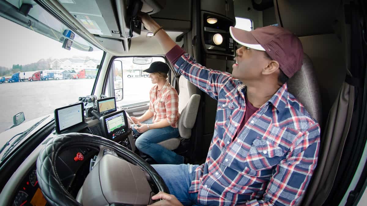 Two truck drivers in a semi's cab.