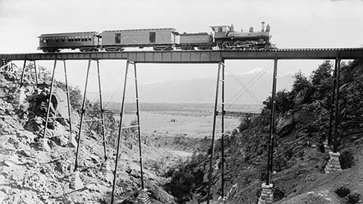 High Bridge Near Buena Vista between 1880 and 1897. A steam engine, coal car, box car and passenger car comprise the train crossing the bridge.