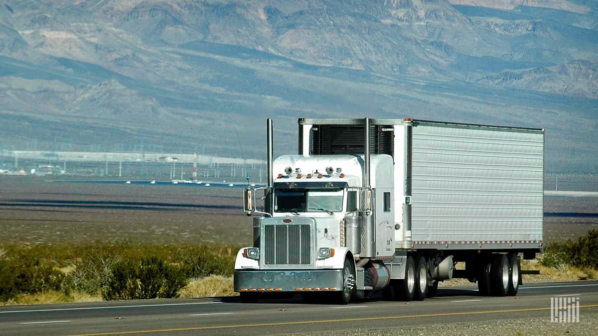 Truck heading down a highway.