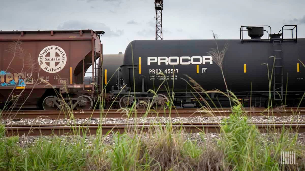 A photograph of railcars parked in a rail yard.