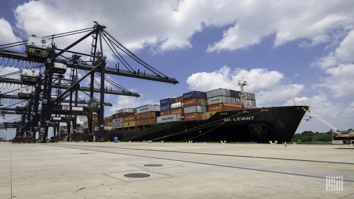 A cargo ship set to unload at dockside.