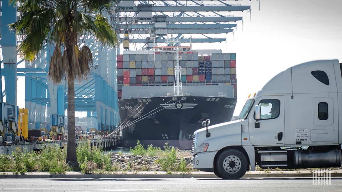 A tractor waits near the docks while a ship is unloaded.