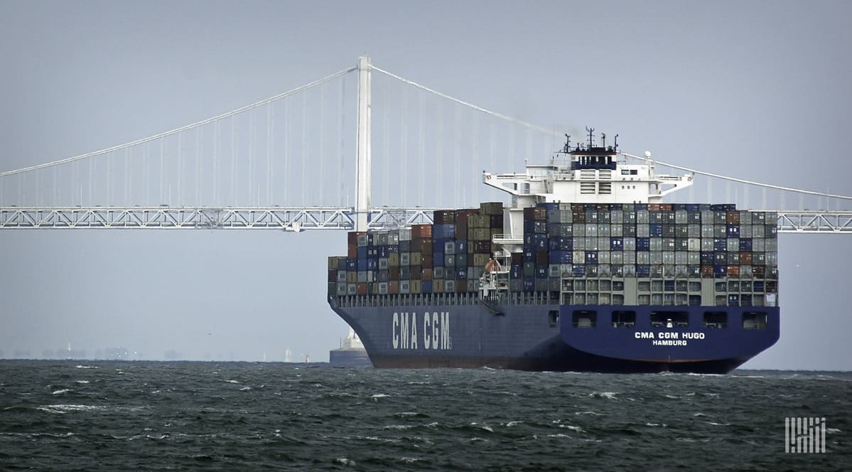 A cargo ship heads toward port with a full load of containers.