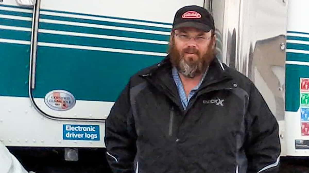 Canadian trucker Jean Pothier standing in front of his truck. He and other Canadian truckers reporting being denied access to medical care unless they self-isolate over COVID-19 fears.