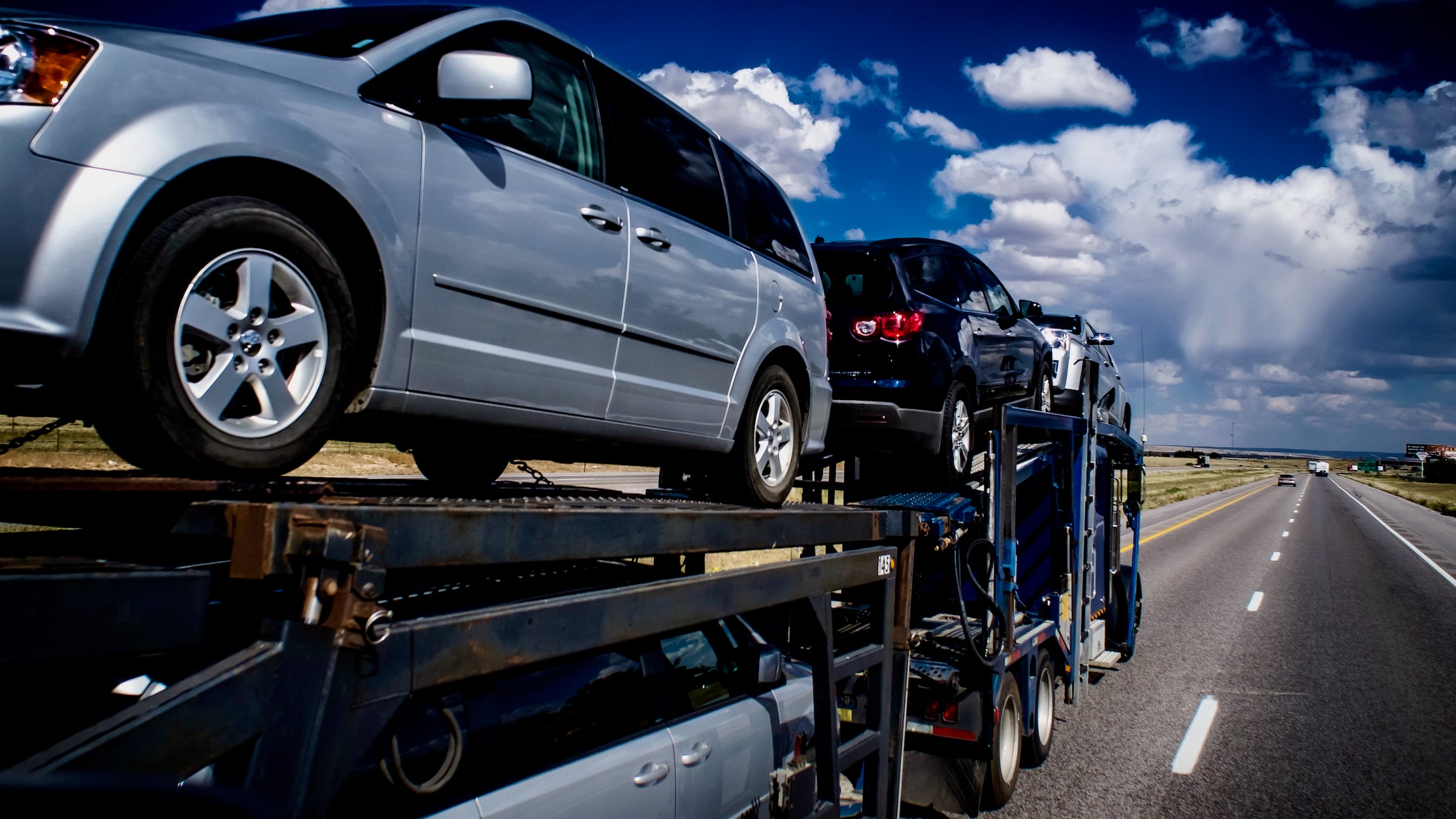 A truck transporting cars to viewed from the front right to illustrate an article about an acquisition by the company Trade X.