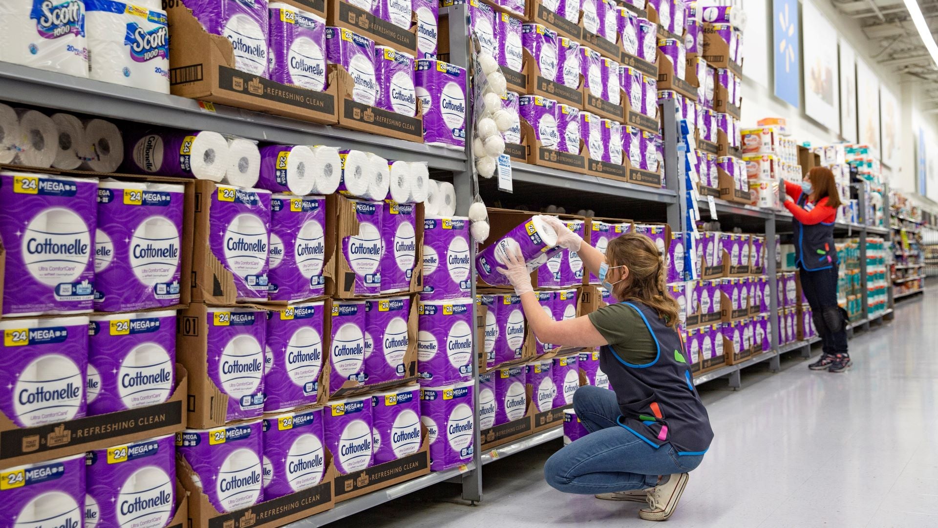 Stacks of toilet paper on shelves at large store.