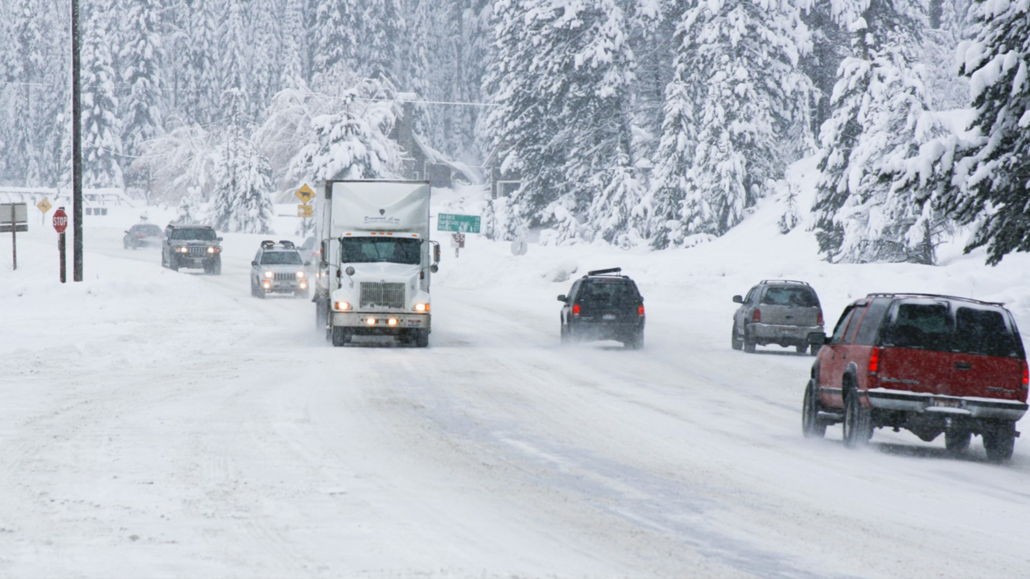 Cars and trucks on a snow Idaho road.