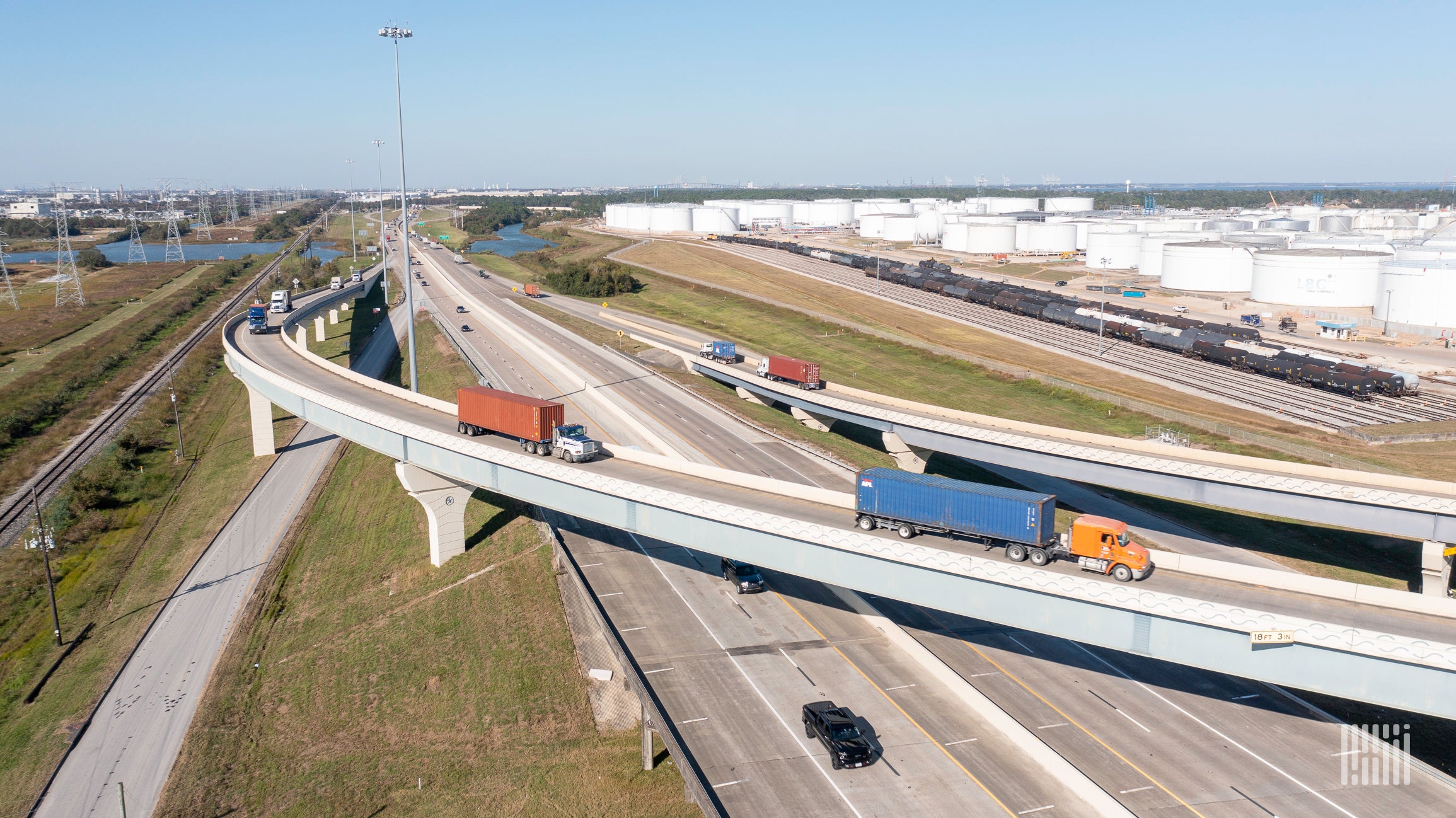 Semi trucks on the road represent AIT Worldwide Logistics and its target to reach net-zero emissions by 2035.