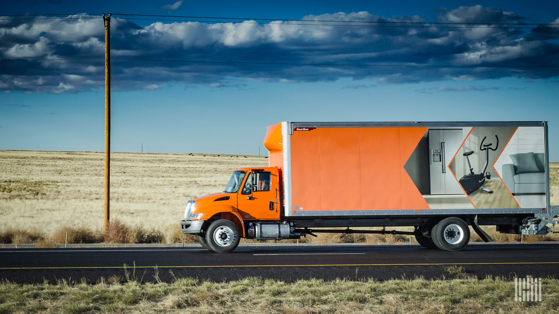 Orange truck on highway