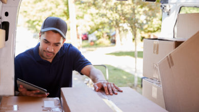 Man unloads boxes from back of van