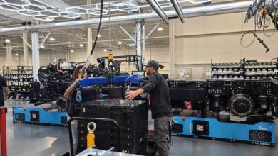 Worker in Nikola plant with Romeo battery pack