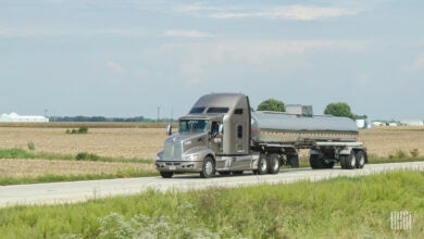 Grey Trimac tractor pulling a stainless steal tank trailer