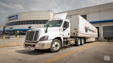 A Forward Air tractor-trailer backed up to a United Airlines cargo terminal