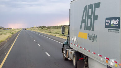 Sideview of an ABF tractor and LTL trailer on a highway